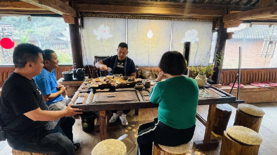图为游客到何俊毅乡愁小店品茶(洪樱绮 摄)