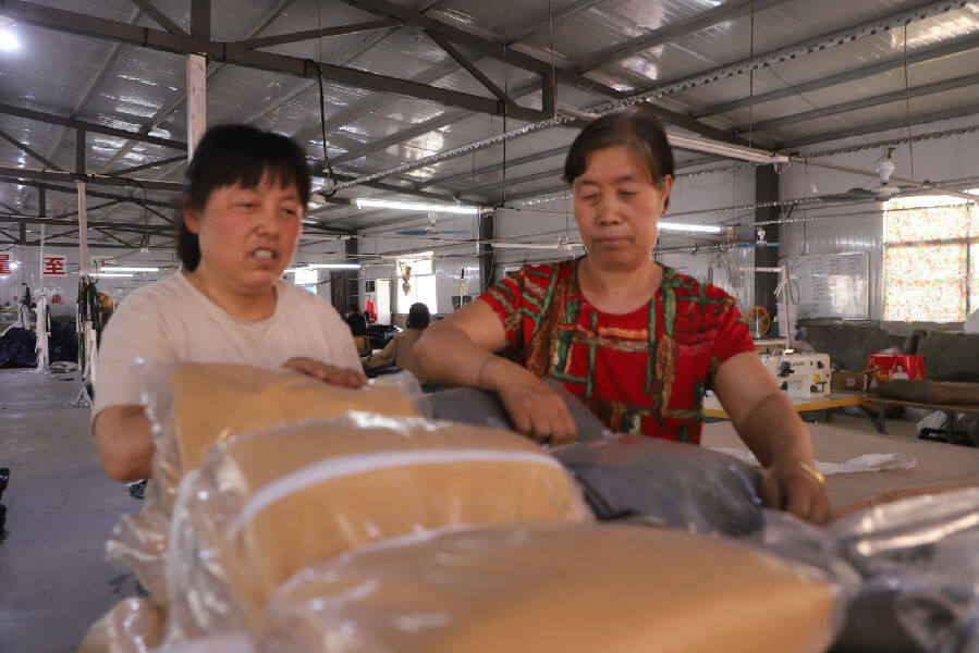 车间员工对帐篷半成品进行码垛（梁国强 摄）