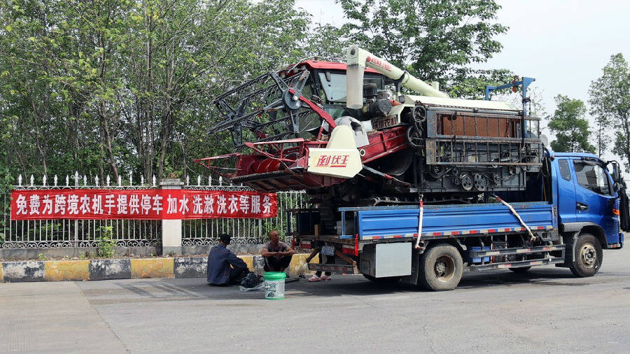 农机手在停放区维修机械（刘毅 摄）